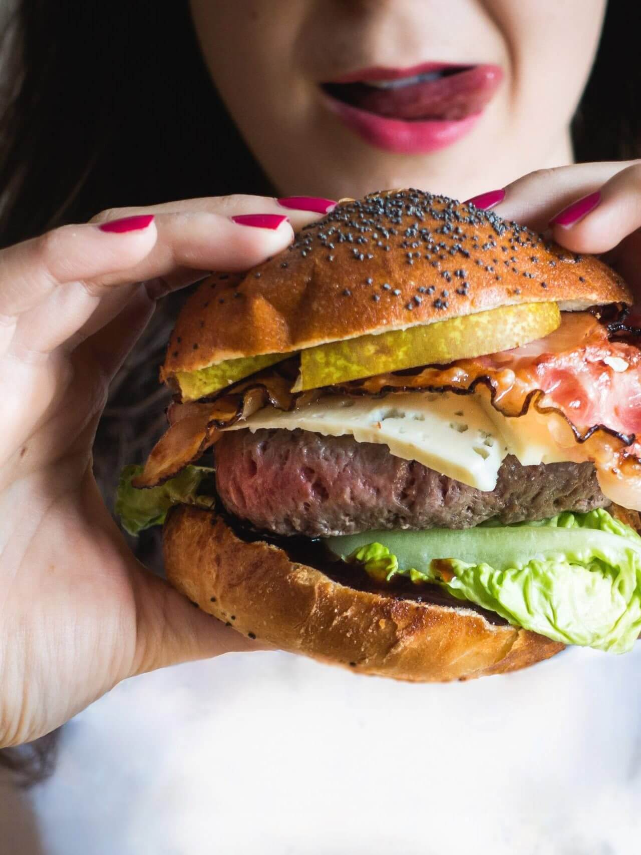 Young lady holding huge burger